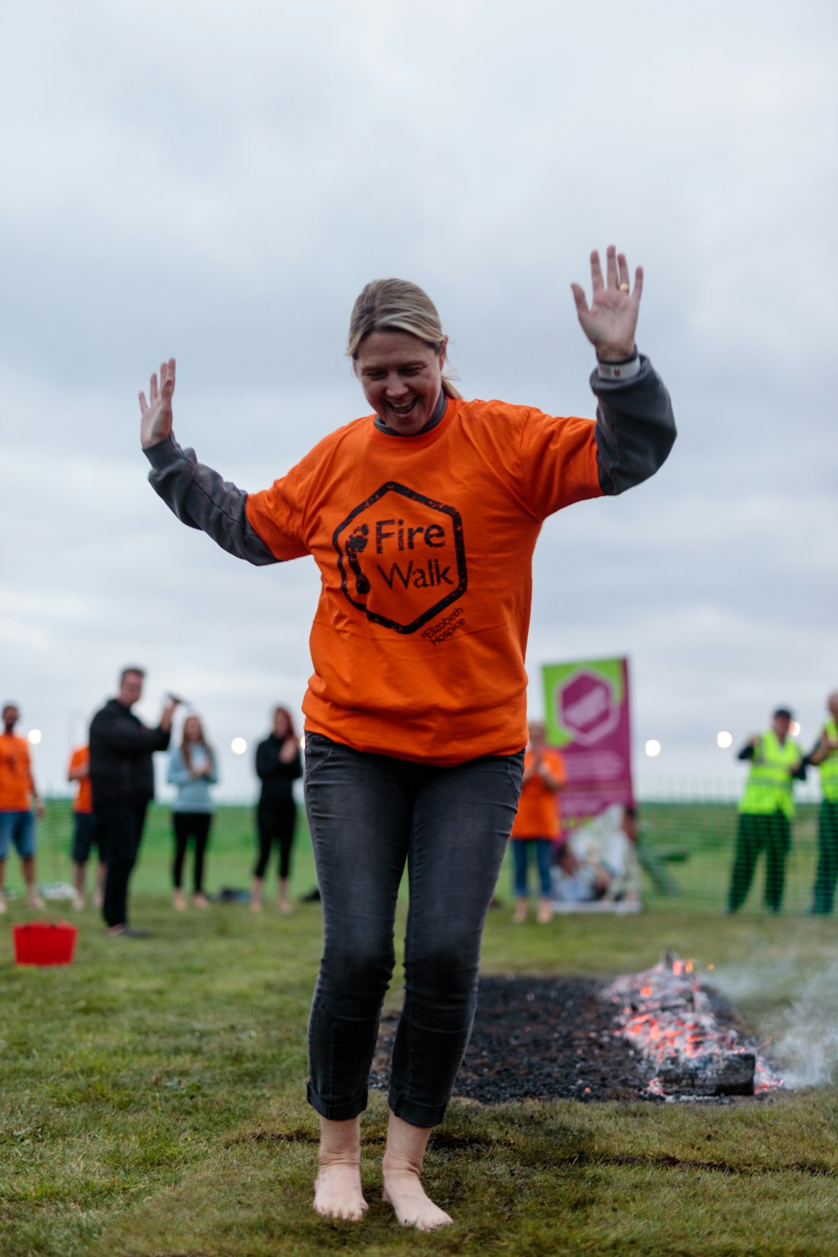 A woman walking across embers